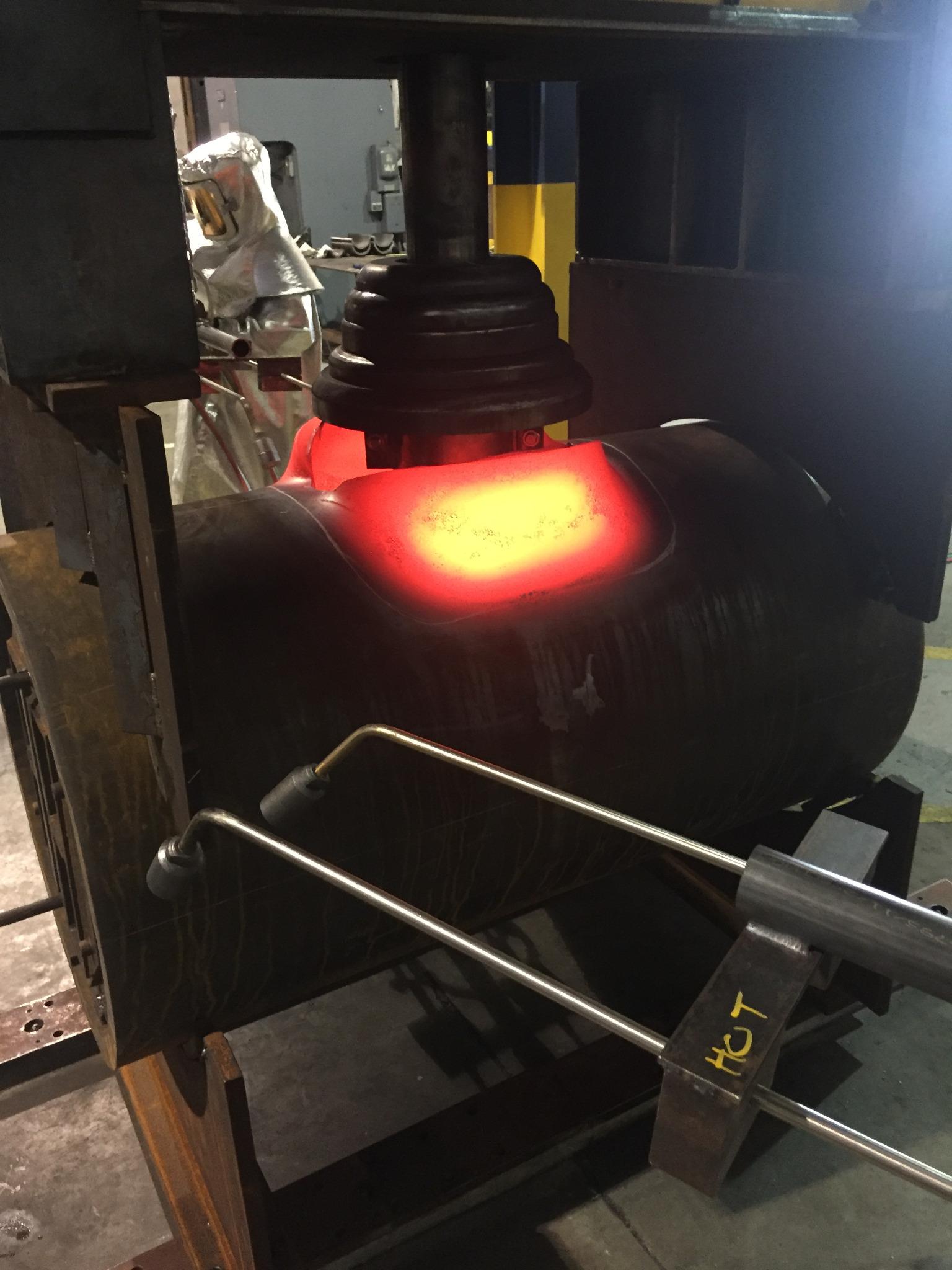 Glowing branch during the initial hot pull on the forming press