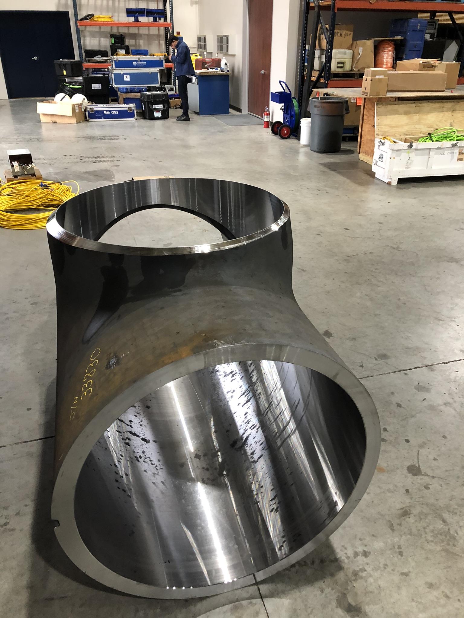 Finished machined extruded tee standing on the shop floor