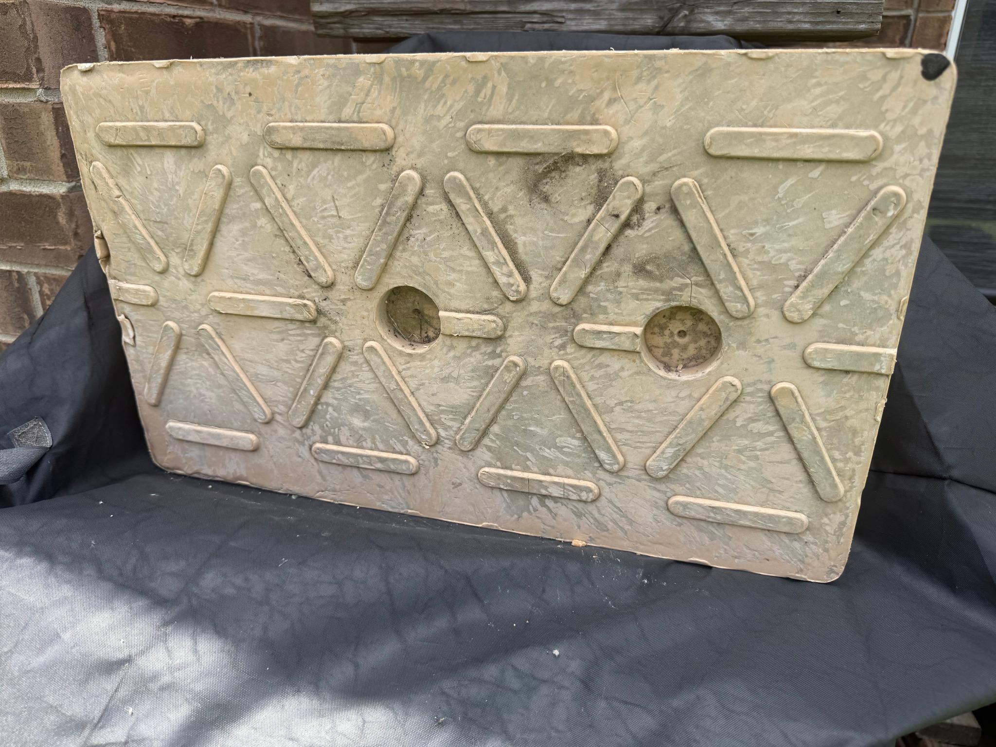 Early composite access mat panel with raised tread bars on the molded surface